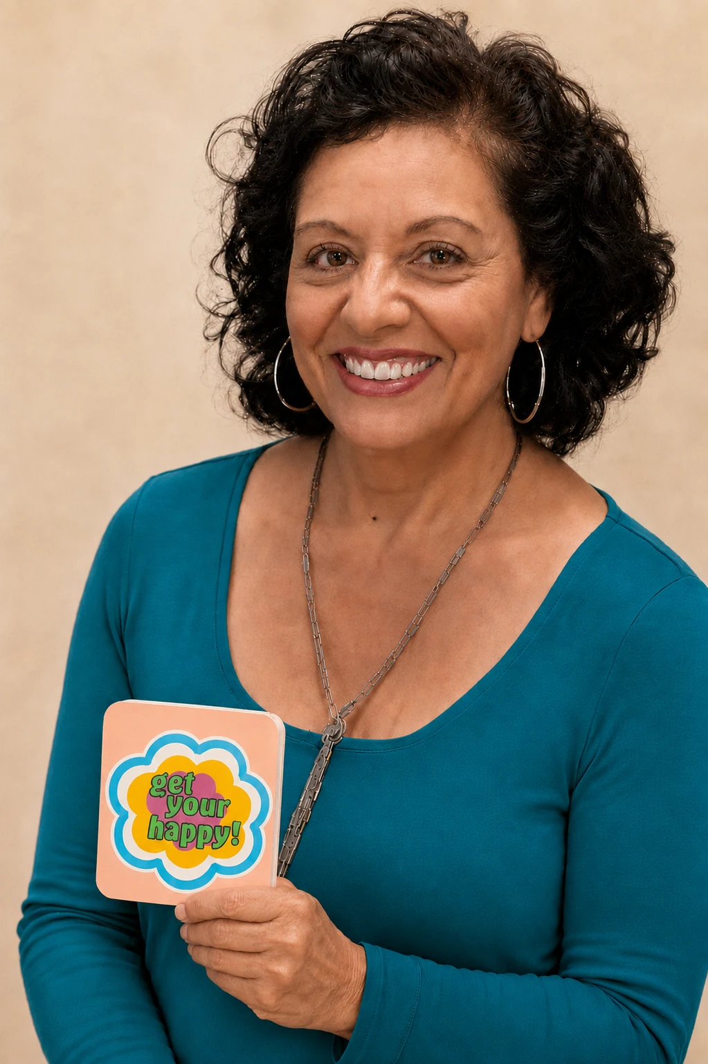 Diana Tenes holding a gift-wrapped Get Your Happy! card deck