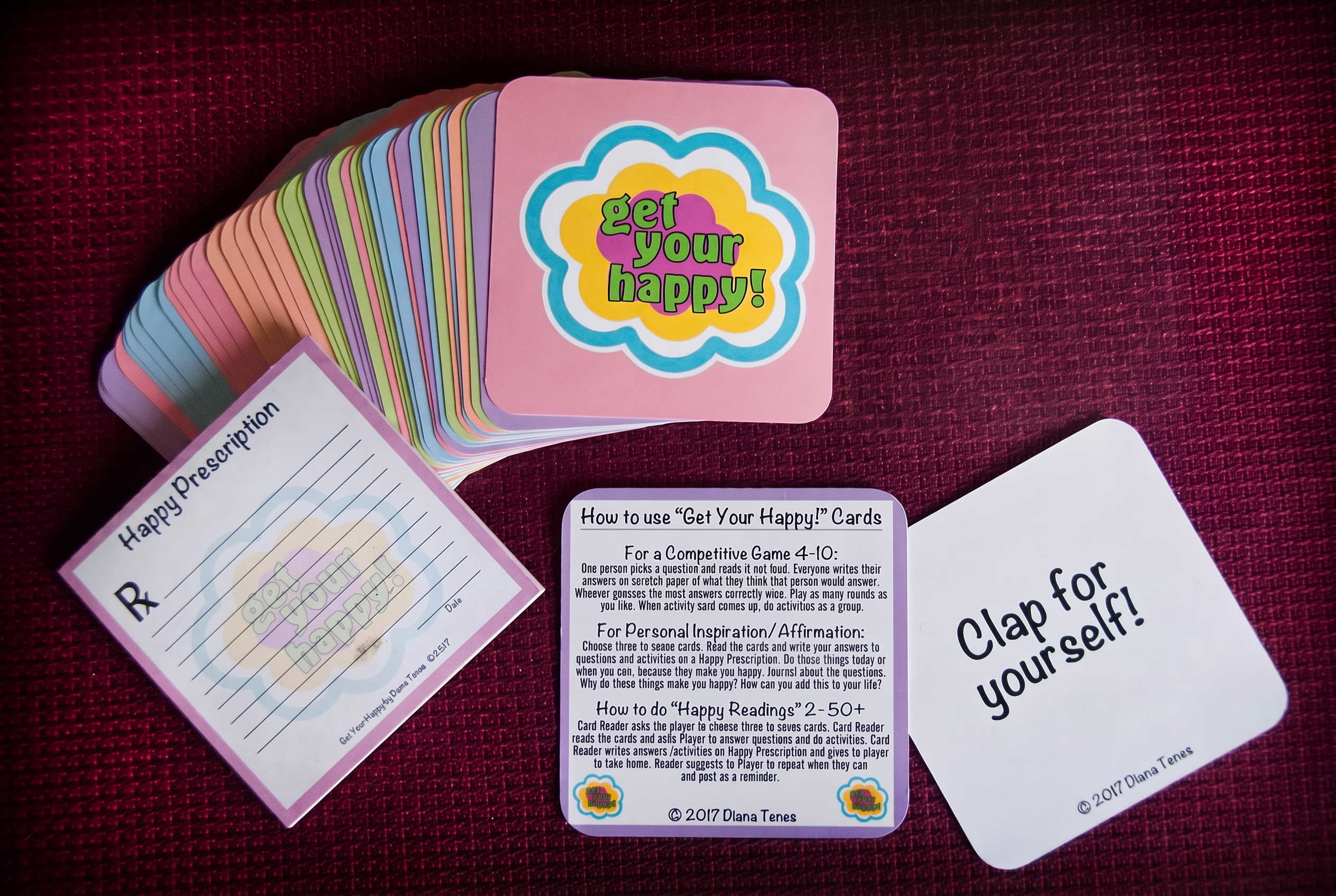 Get Your Happy! 54-Card Full Experience Deck with the fanned card set, prescription pad and instruction cards on a teal background.