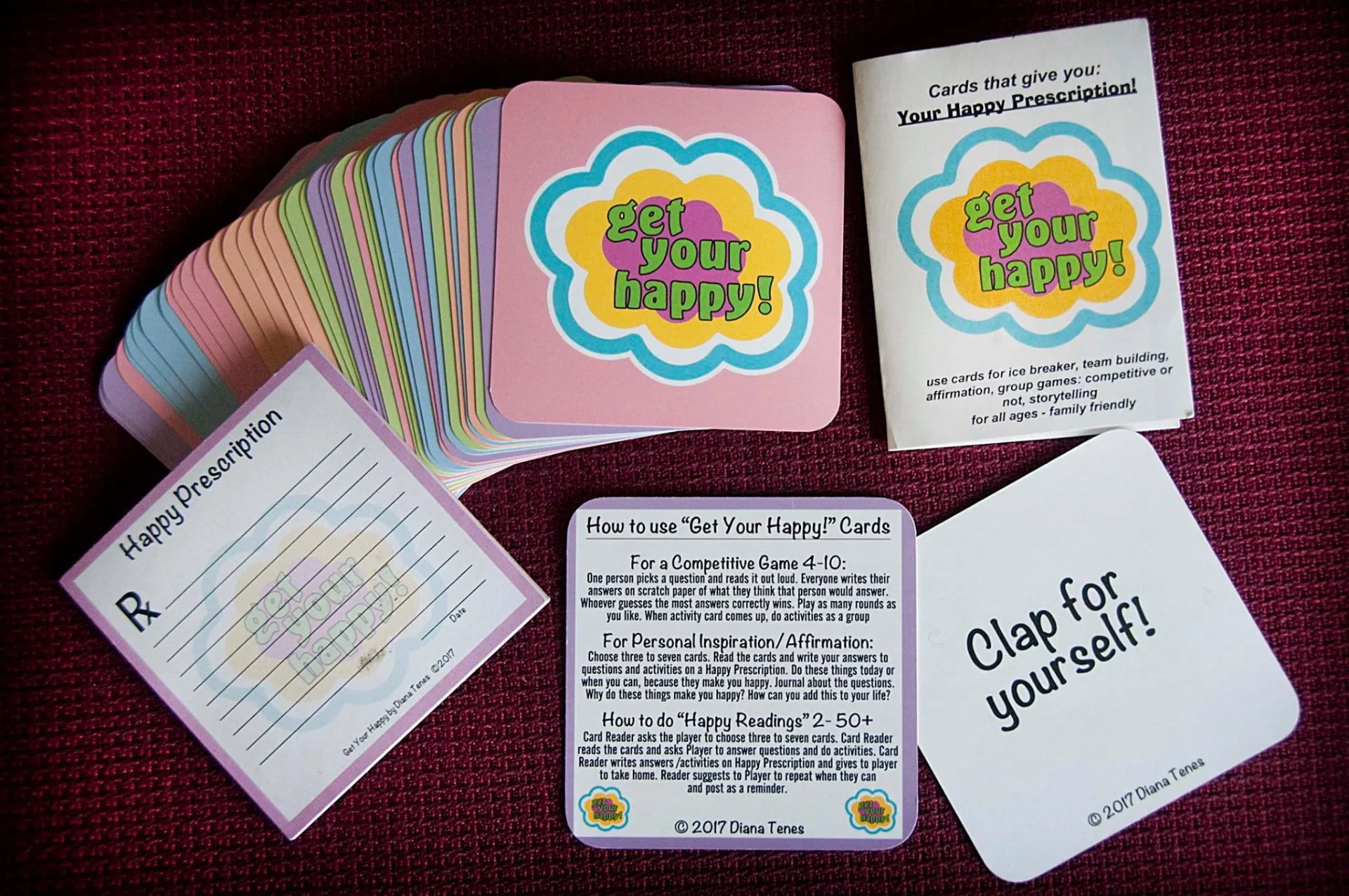 Get Your Happy! 26-Card Classic Deck with printed instruction card laid out on a teal background.