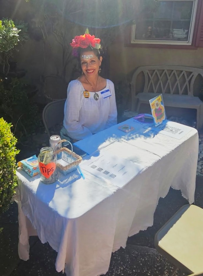 Diana Tenes offering Get Your Happy conversation card readings at an outdoor goddess party.