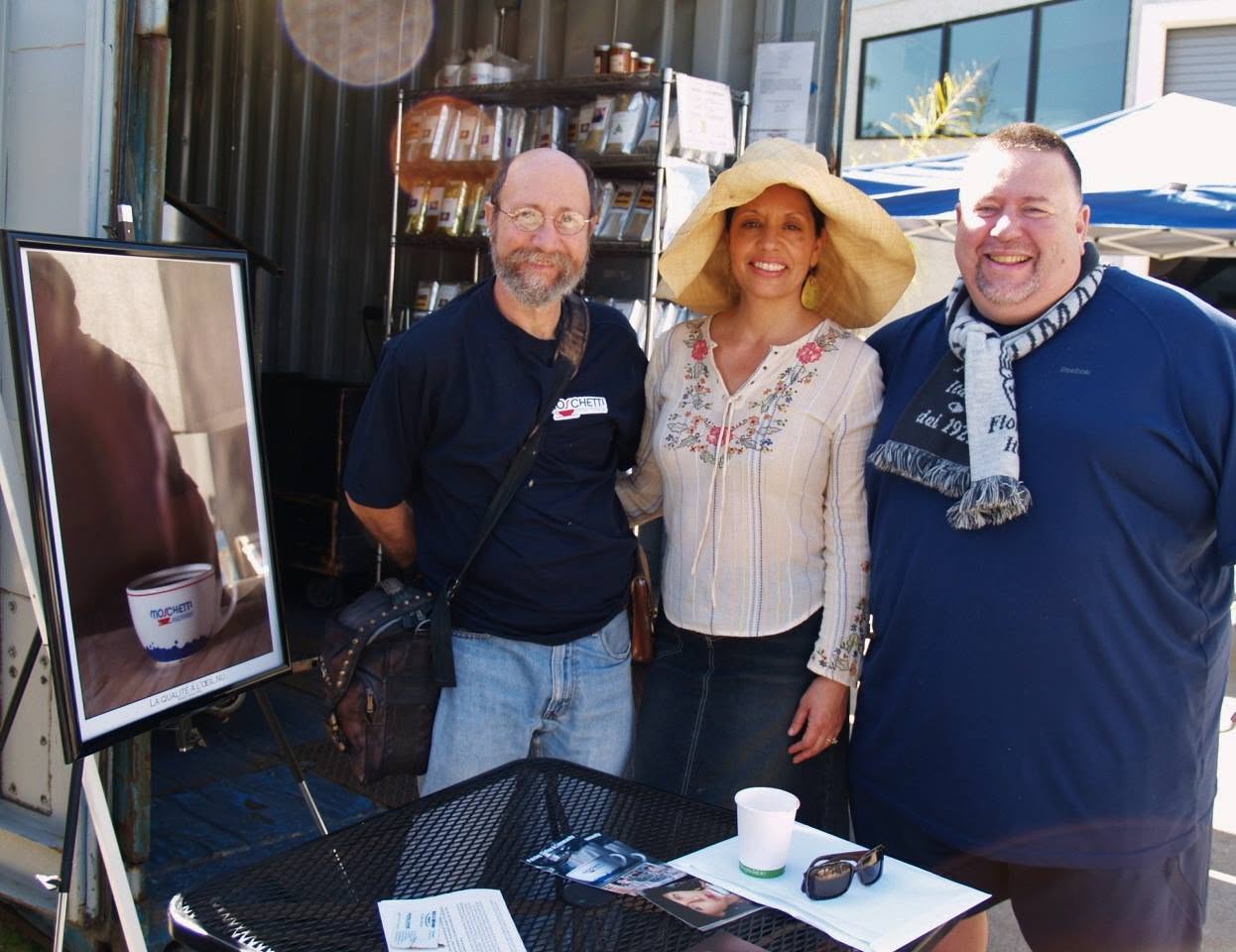 Diana Tenes with Fabrice and Stephen at her Get Your Happy!® card-reading table outside Moschetti Coffee Roaster in Vallejo.
